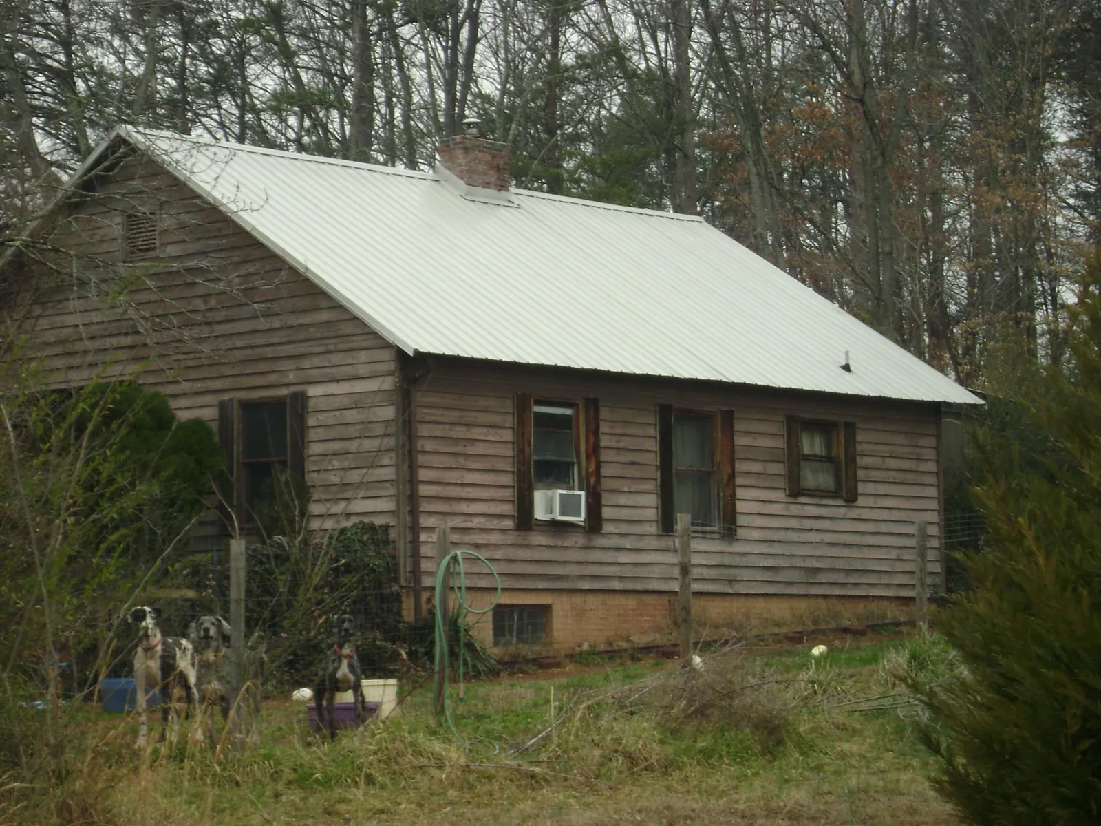 White metal roof on an old wood sided farmhouse, from a Metal Roof Installation job in Shenandoah
